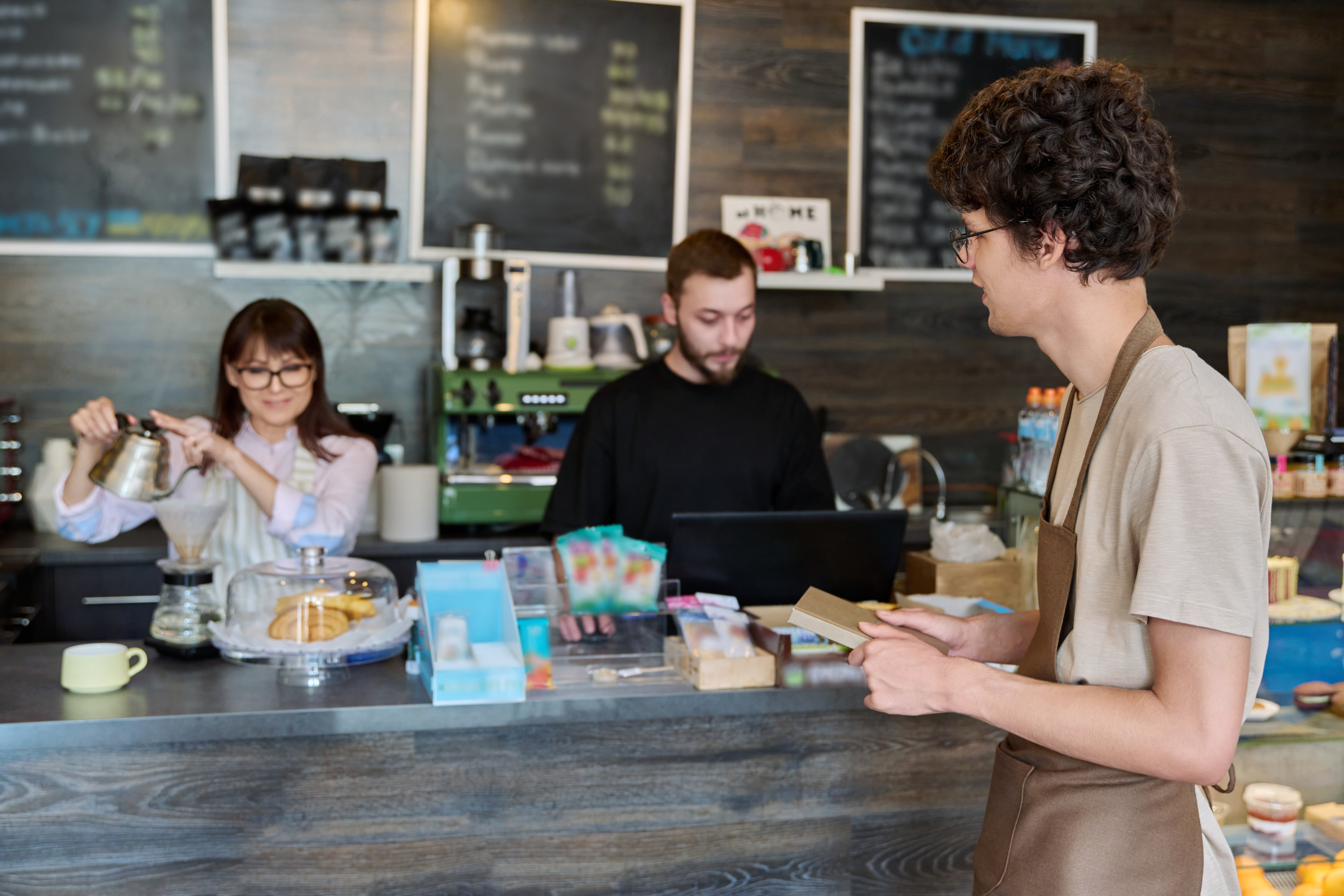 coffee-shop-workers-a-young-guy-in-an-apron-in-fo-2023-11-27-05-26-30-utc.jpg